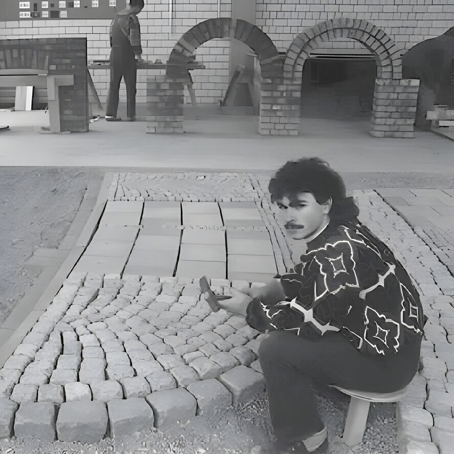 black and white picture of an apprentice paving stones