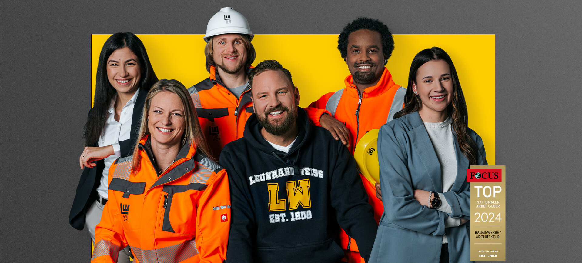 Gruppe von sechs lächelnden Personen in Business- und Schutzkleidung vor gelb-grauem Hintergrund mit „TOP Arbeitgeber 2024“-Auszeichnung